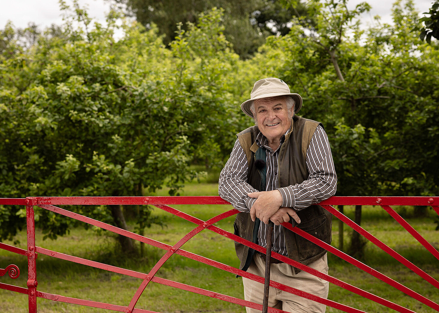 Rod leaning on Sunburst gate - Highbank Orchards Self-Guided 'Red Gate' Walk
