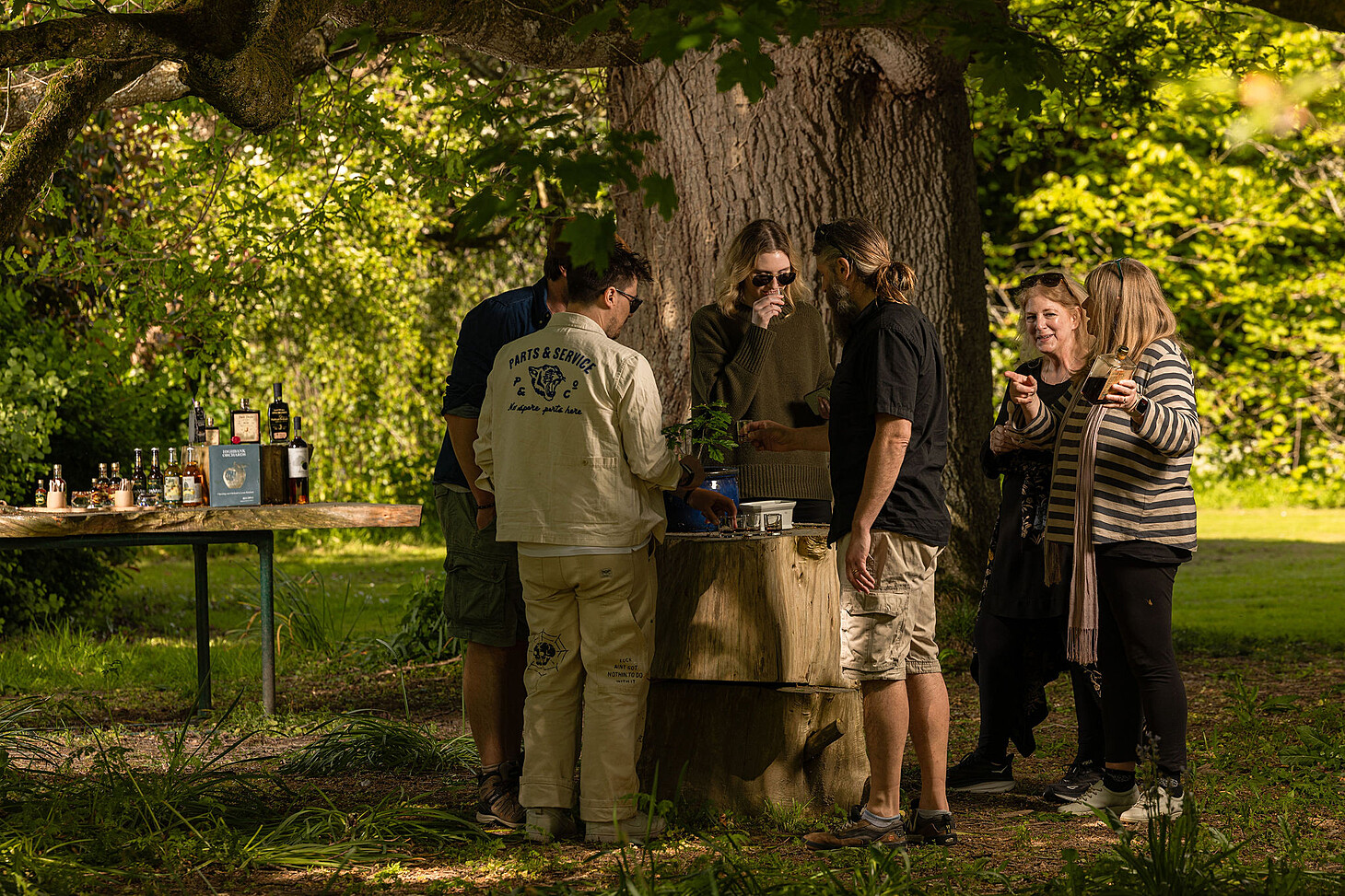 Tour Group tasting Highbank products under the Large Oak tree