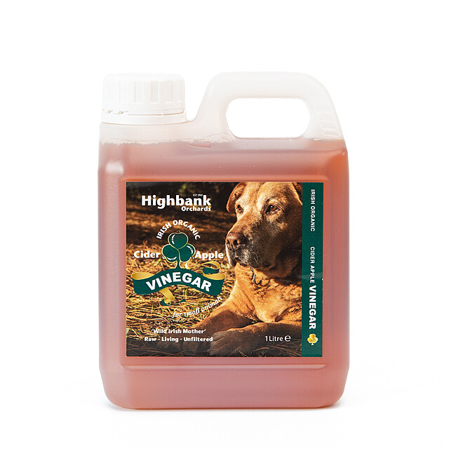 One litre container containing apple cider vinegar with picture of golden labrador