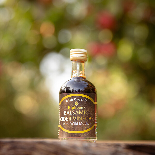 50ml mini bottle of balsamic vinegar on wood in the orchards.