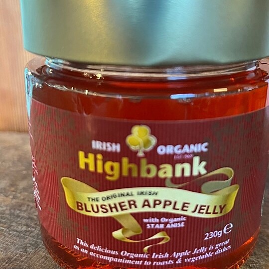 gold topped jar full of red apple jelly